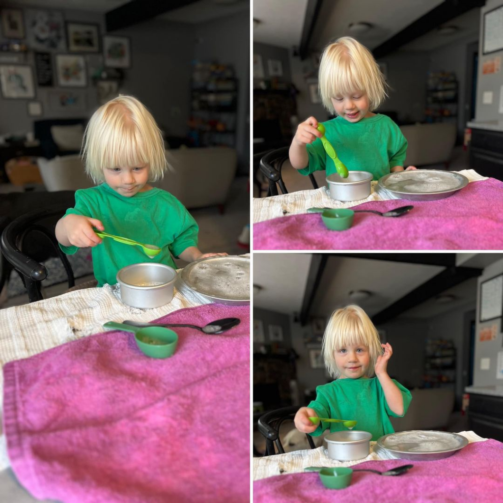 A child at play with spoons and pans